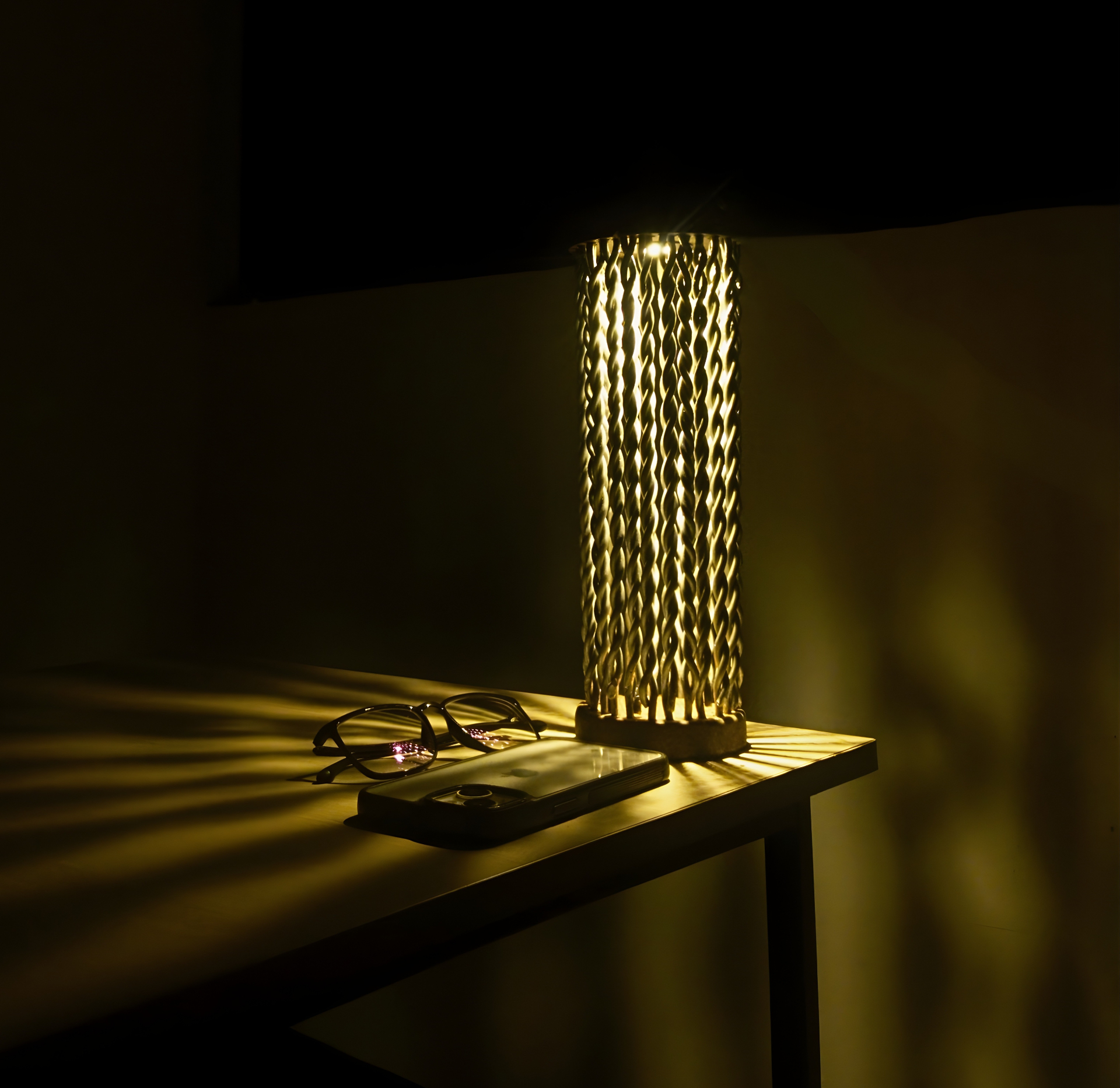 LUMOS lamp glowing on a desk, casting radial shadows