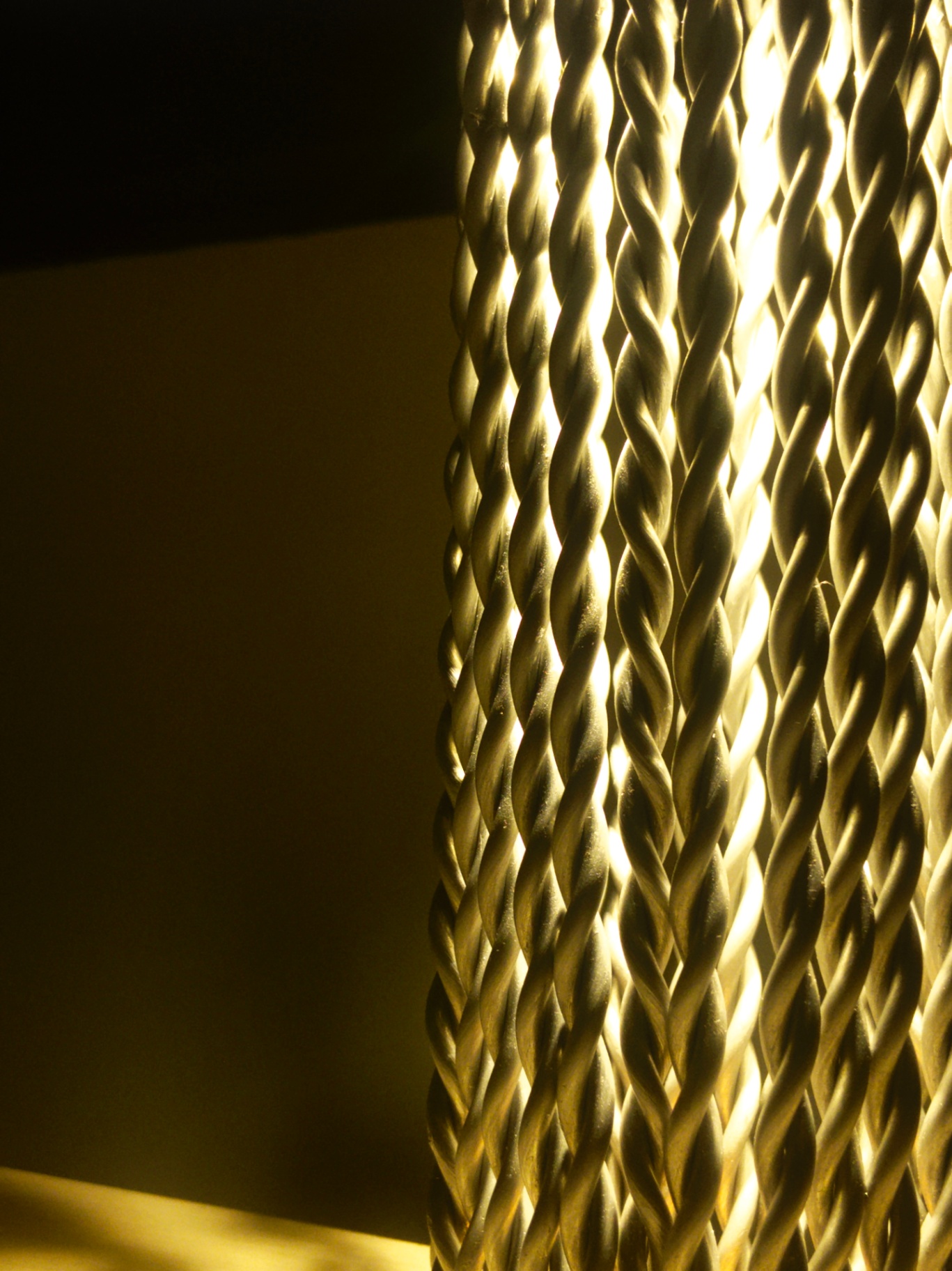 Close-up of twisted aluminium rods catching light